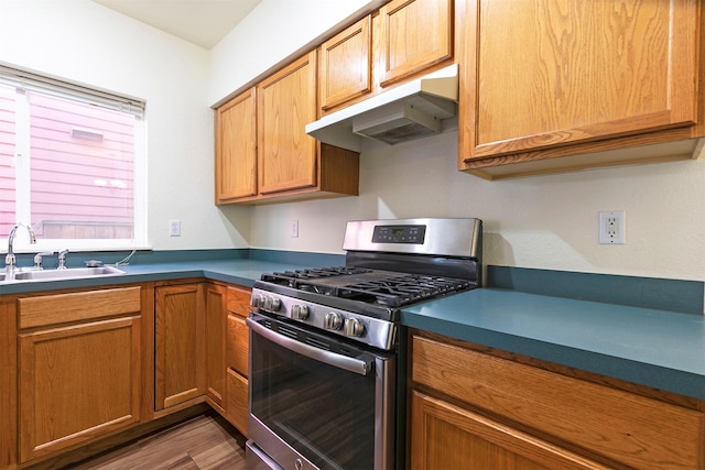 1312 Bridgecourt Way, Missoula, MT 59801 - kitchen featuring stainless steel gas stove, under cabinet range hood, a sink, dark wood-style floors, and dark countertops
