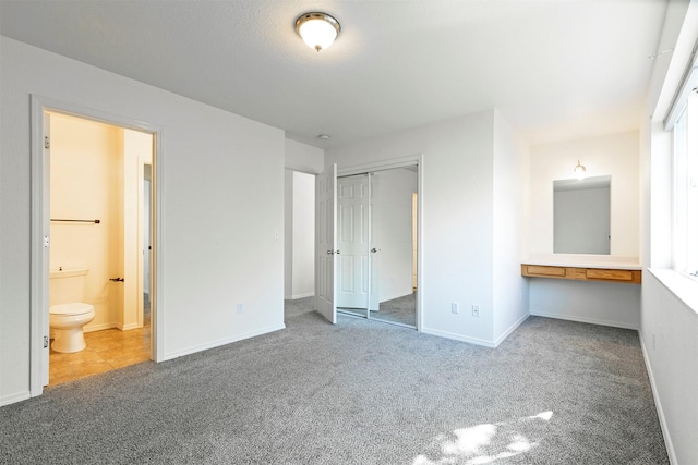 1312 Bridgecourt Way, Missoula, MT 59801 - unfurnished bedroom with carpet, a closet, ensuite bathroom, and baseboards