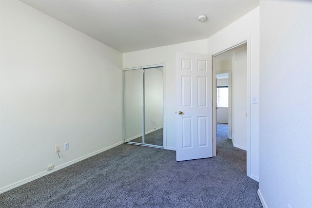 1312 Bridgecourt Way, Missoula, MT 59801 - unfurnished bedroom with dark colored carpet, baseboards, and a closet