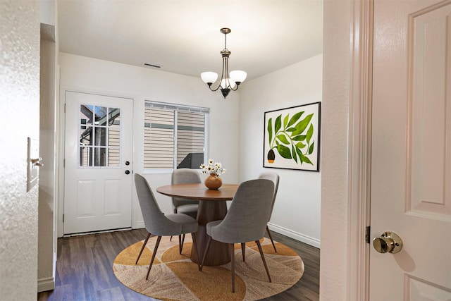 1312 Bridgecourt Way, Missoula, MT 59801 - dining room with dark wood finished floors, a chandelier, and baseboards