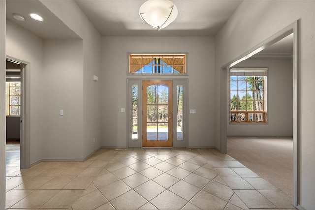 entrance foyer with baseboards, recessed lighting, a healthy amount of sunlight, and light tile patterned flooring