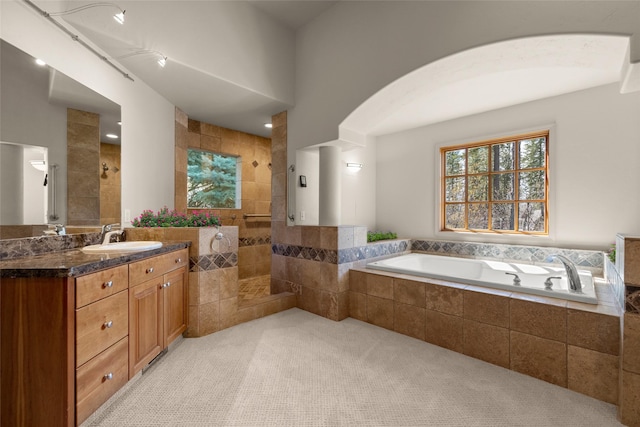 full bathroom with walk in shower, vanity, and a bath
