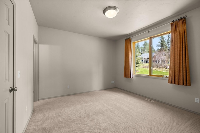unfurnished bedroom featuring visible vents, light carpet, and baseboards