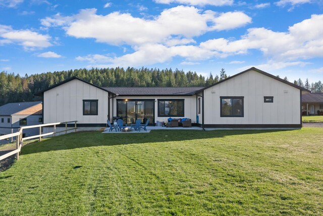 21 Bear Paw Loop, Bigfork, MT 59911 - back of property featuring board and batten siding, an outdoor living space, and a patio area
