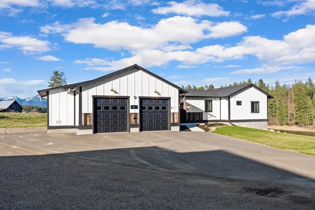 21 Bear Paw Loop, Bigfork, MT 59911 - view of front facade with board and batten siding and an outdoor structure