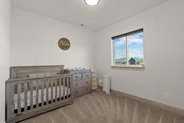 21 Bear Paw Loop, Bigfork, MT 59911 - bedroom featuring carpet floors and a crib