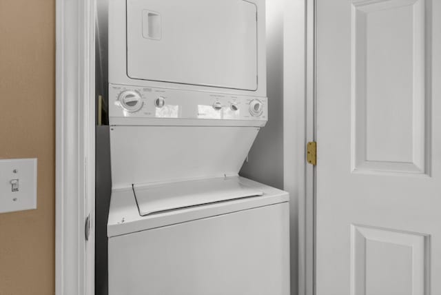 washroom featuring stacked washing maching and dryer and laundry area