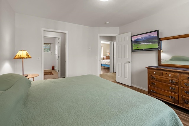 bedroom with wood finished floors and baseboards