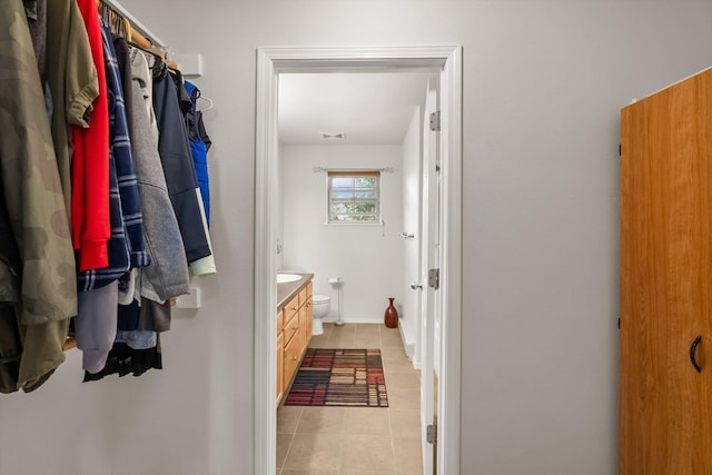 bathroom featuring visible vents, baseboards, toilet, vanity, and tile patterned flooring