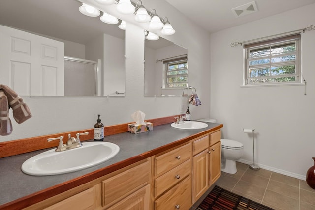 full bath featuring tile patterned floors, visible vents, a shower stall, and a sink