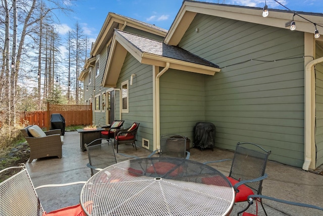 exterior space featuring fence, an outdoor fire pit, and outdoor dining area