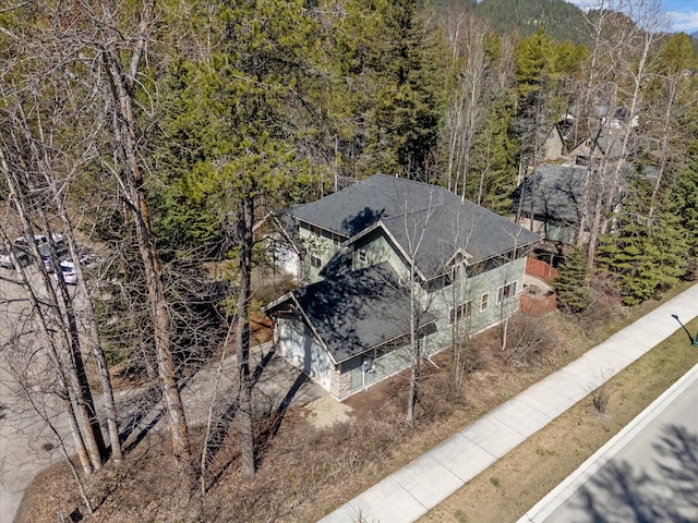 birds eye view of property with a view of trees
