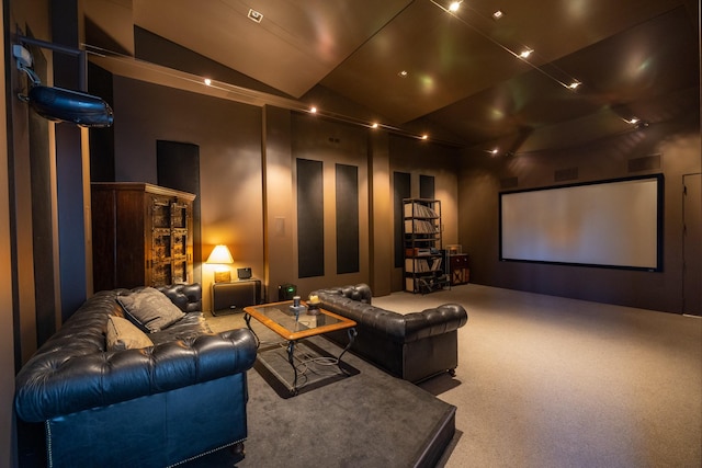 carpeted home theater with vaulted ceiling