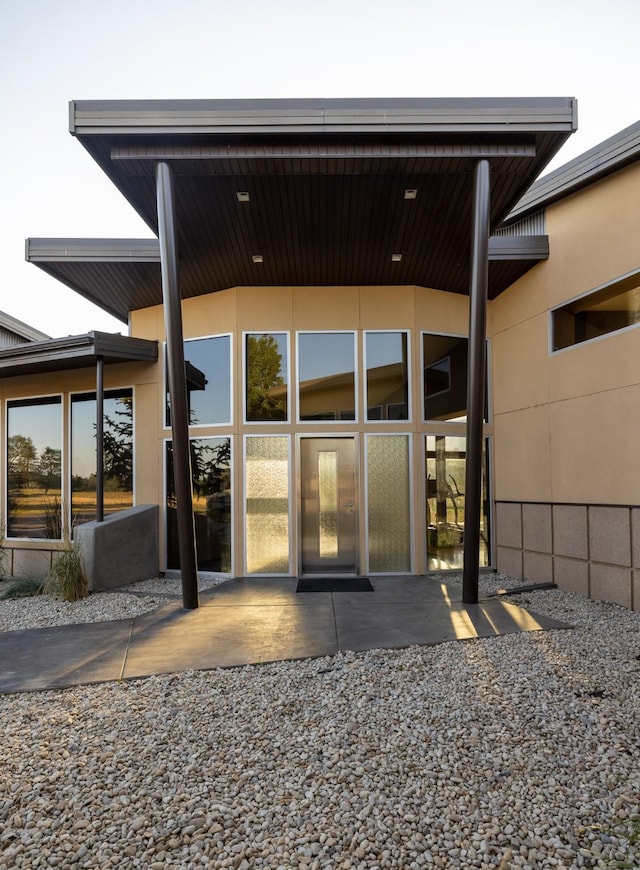 doorway to property featuring fence