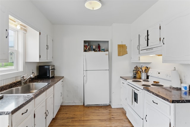 648 7th Ave W, Kalispell, MT 59901 - kitchen featuring white appliances, a sink, under cabinet range hood, dark countertops, and light wood-type flooring