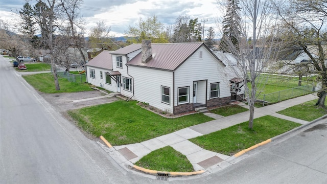 648 7th Ave W, Kalispell, MT 59901 - view of front of house with metal roof, a chimney, and stone siding