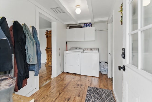 648 7th Ave W, Kalispell, MT 59901 - washroom with separate washer and dryer, light wood-type flooring, and cabinet space