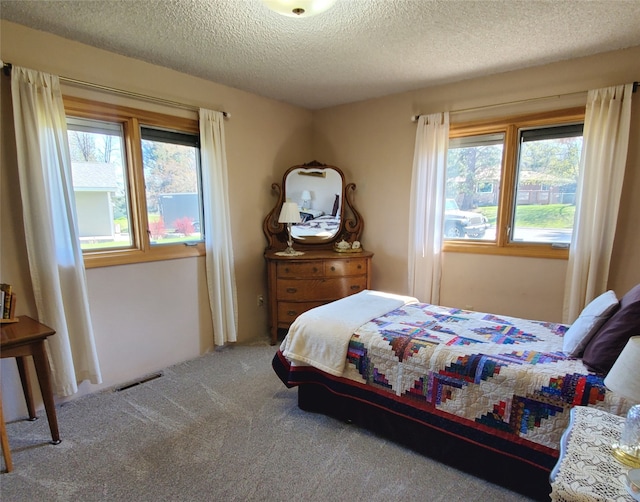 3208 Paul Ln, Missoula, MT 59803 - bedroom featuring visible vents, a textured ceiling, and carpet flooring
