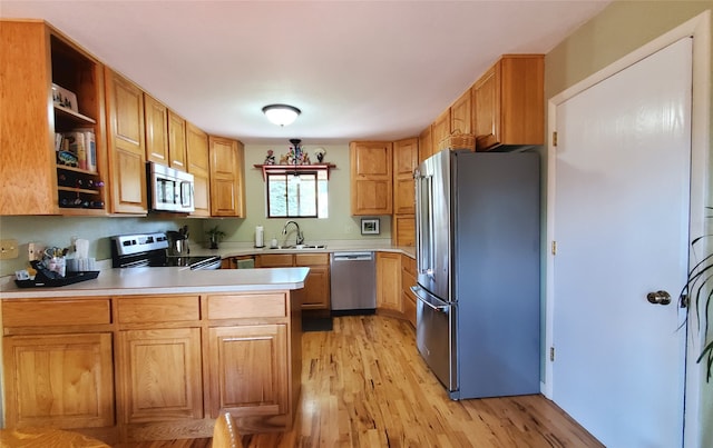 3208 Paul Ln, Missoula, MT 59803 - kitchen with light wood-style floors, stainless steel appliances, open shelves, and a sink