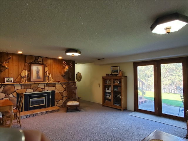 3208 Paul Ln, Missoula, MT 59803 - living area with wood walls, a fireplace, a textured ceiling, and carpet floors