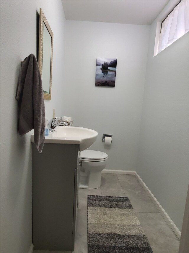 3208 Paul Ln, Missoula, MT 59803 - half bathroom featuring toilet, vanity, and baseboards