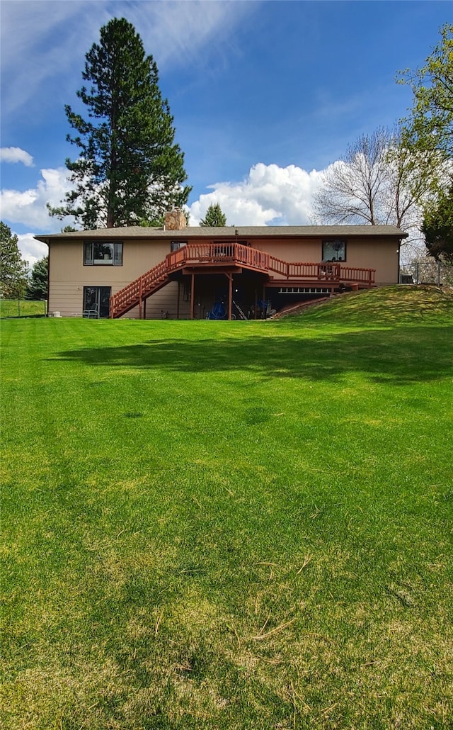 3208 Paul Ln, Missoula, MT 59803 - rear view of property featuring stairway, a wooden deck, and a yard