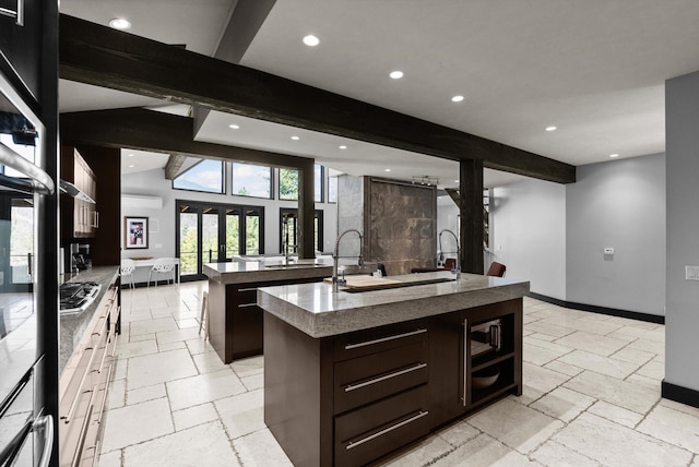 15 Copper Ridge Rd, Trout Creek, MT 59874 - kitchen featuring an island with sink, stone tile floors, recessed lighting, dark brown cabinetry, and baseboards