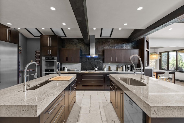 15 Copper Ridge Rd, Trout Creek, MT 59874 - kitchen featuring a large island, wall chimney exhaust hood, a sink, appliances with stainless steel finishes, and stone tile floors