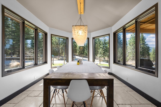 15 Copper Ridge Rd, Trout Creek, MT 59874 - sunroom featuring stone tile flooring, baseboards, a chandelier, and vaulted ceiling