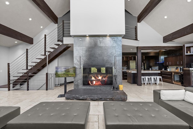 15 Copper Ridge Rd, Trout Creek, MT 59874 - living area with beamed ceiling, high vaulted ceiling, a tile fireplace, recessed lighting, and stairs
