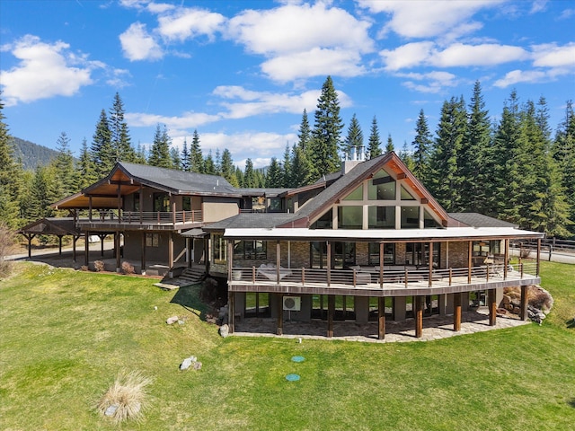 15 Copper Ridge Rd, Trout Creek, MT 59874 - rear view of property with a deck, a yard, and a forest view