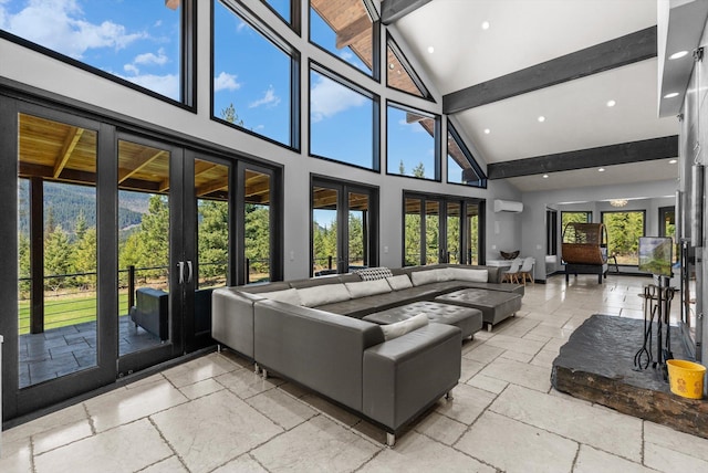 15 Copper Ridge Rd, Trout Creek, MT 59874 - living area with stone tile flooring, french doors, beam ceiling, high vaulted ceiling, and a wall mounted AC