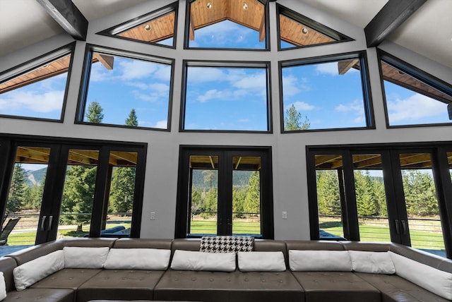 15 Copper Ridge Rd, Trout Creek, MT 59874 - unfurnished living room featuring beam ceiling, high vaulted ceiling, and healthy amount of natural light