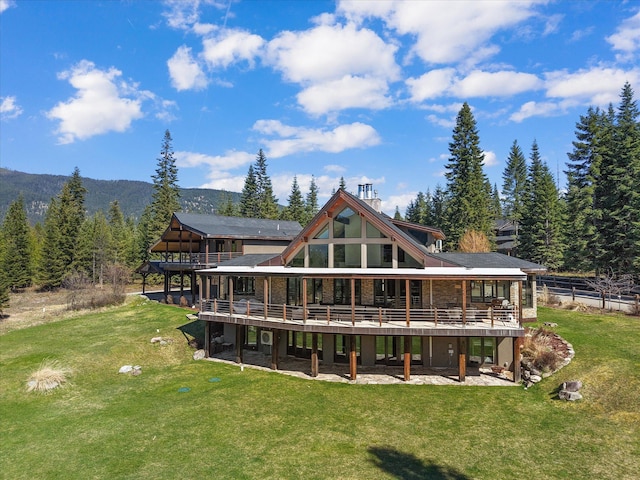 15 Copper Ridge Rd, Trout Creek, MT 59874 - rear view of property with a wooden deck and a lawn