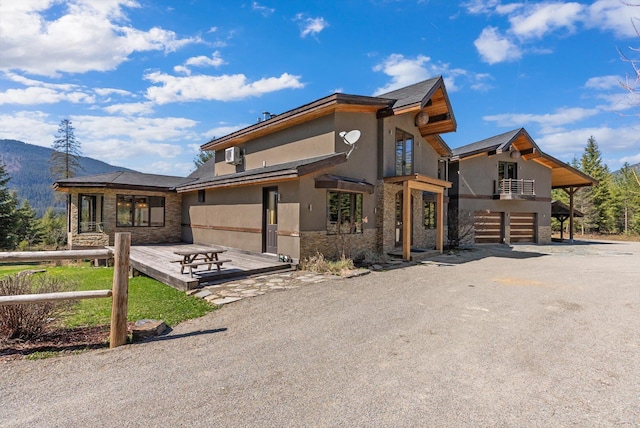 15 Copper Ridge Rd, Trout Creek, MT 59874 - contemporary house with stone siding, a garage, stucco siding, and a balcony