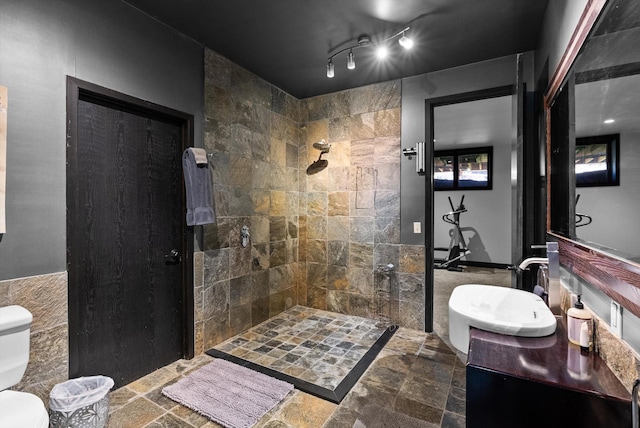 15 Copper Ridge Rd, Trout Creek, MT 59874 - bathroom with walk in shower, toilet, tile walls, vanity, and stone finish flooring