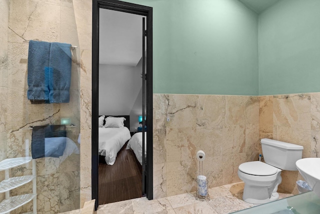 15 Copper Ridge Rd, Trout Creek, MT 59874 - bathroom featuring toilet, ensuite bath, and tile walls