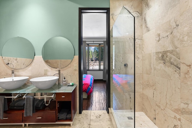 15 Copper Ridge Rd, Trout Creek, MT 59874 - full bathroom with tile walls, ensuite bath, double vanity, a walk in shower, and wood finished floors
