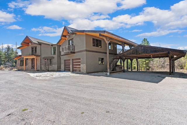 15 Copper Ridge Rd, Trout Creek, MT 59874 - view of side of property with stucco siding, stone siding, stairs, and a garage