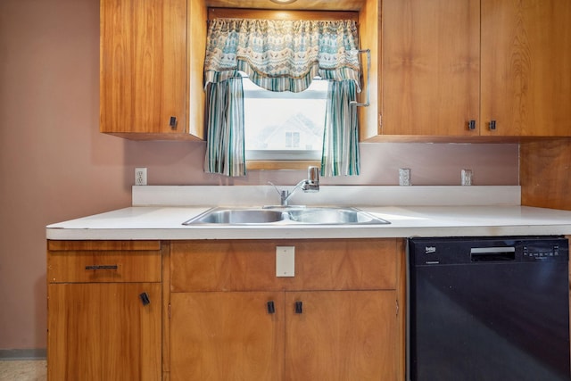 kitchen featuring black dishwasher, a sink, brown cabinets, and light countertops