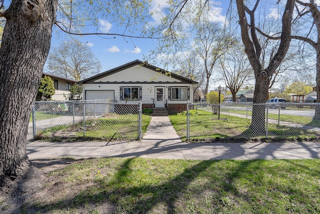 bungalow-style house with a front yard, driveway, a garage, and a fenced front yard