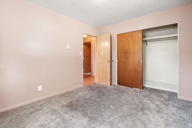 unfurnished bedroom featuring a closet, carpet, and baseboards