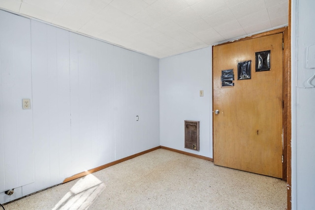 empty room featuring baseboards