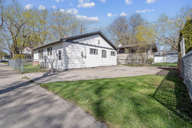 view of side of property featuring a lawn, fence, and a patio
