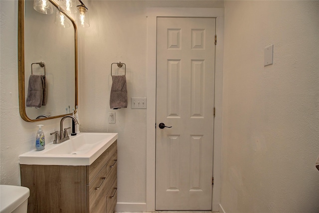 half bath featuring toilet and vanity