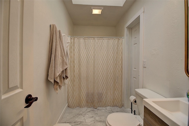 bathroom with toilet, a shower with curtain, vanity, and marble finish floor