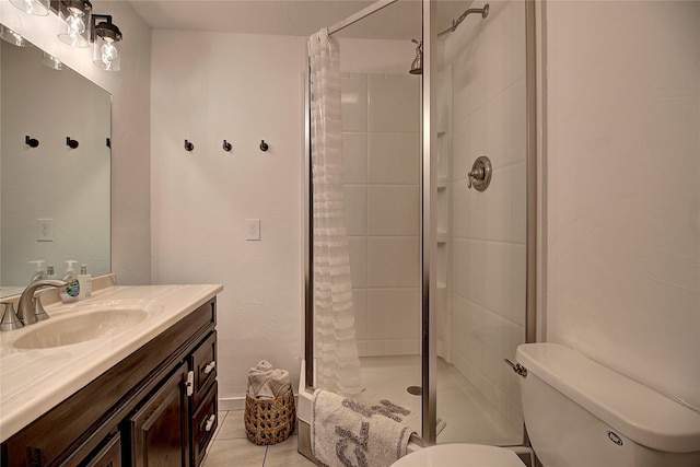 bathroom with tile patterned floors, vanity, toilet, and a shower stall
