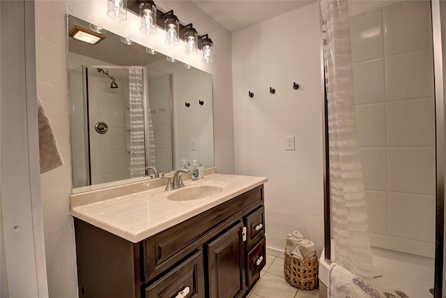 full bathroom with vanity, a shower stall, and tile patterned floors