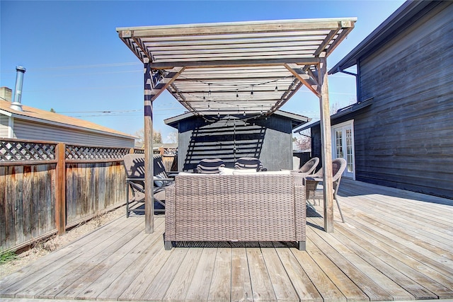 wooden terrace with a pergola, outdoor dining space, and fence