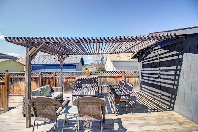 wooden terrace featuring outdoor lounge area, fence, and a pergola